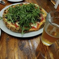 Vegan pizza with arugula. mushrooms and a vegan cashew cheese.  at Via Tevere Pizzeria Napoletana in Vancouver
