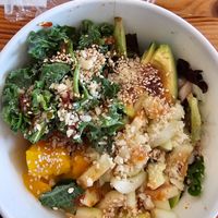 Half rice, half mixed greens with tofu, mango, kale, Cucumbers, avacado, sesame seeds, macadamia nuts with sweet chili sauce. at Poke Mian in Stafford