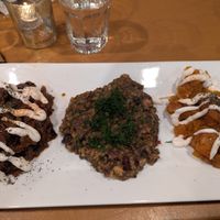 Risotto with sides of roasted eggplant and pumpkin.  The eggplant and pumpkin are drizzled with oat yogurt.  Delicious! at Afghan Bistro in Springfield