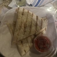 Quesadilla with sliced potatoes and green onions inside and a side of salsa  at Bartlet Street in Andover