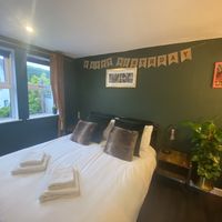 Double bedroom with some thoughtful decoration!  at Greenstone Lodge  in Bridge Of Orchy