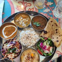 thali ft. a range of curries, cabbage, rice, pandan, paratha, sweet yellow lentil, and black bean. pappadam appetizer not pictured at Tula in Montreal