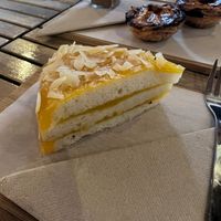 Vegan cake and NON VEGAN Pasteis de Natas in the background  at Gato Legal Coffee Roastery in Ponta Do Pargo