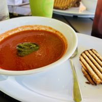 Tomato basil soup with vegan bread, Vegan Delight Smoothie and unsweetened iced tea in the background   at Something Healthy Cafe in Sierra Madre