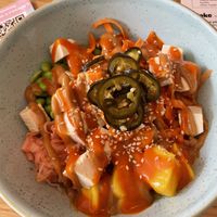 Spicy tofu and veg bowl with brown rice base, peanut sauce and coconut sriracha sauce.   at Peeld in East London