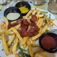 Salchipapas, not good, hard chips and weird sausages at Loving Hut - Titikaka in Puno