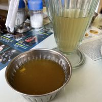 Drink (some sort of hot, watery lemon tea I didn’t love) and dessert, a gloopy fruit syrup thingy   at Loving Hut - Titikaka in Puno