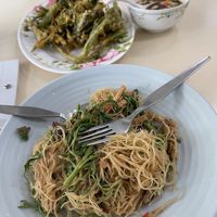 Fried noodles accompanied by deep friend morning glory with dipping sauce.   at Sutunthip Vegetarian Food in Bangkok