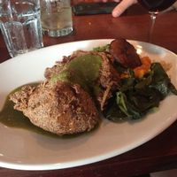Blue corn crusted seitan medallions with yams, black beans, rice, greens and tomatillo sauce at New World Bistro Bar in Albany