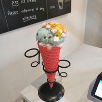 Candyfloss and cookie monster with mango sauce and marshmallows in a strawberry cone at Lick in Bakewell