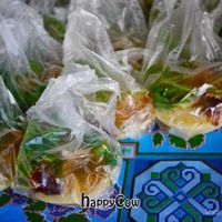 Sacks of yellow tofu with condiments at Weekly Market in Chiang Mai