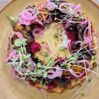 Farinata: housemade chickpea flatbread with beetroot hummus, mushroom, pumpkin, herbs and red onion at Picnic Real Food Bar in Tamborine Mountain