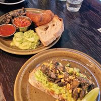 Avocado bread with mushrooms and 'vegan brekkie' with sausage, potato crisp, beans and mushrooms at Brunchoteket in Malmo