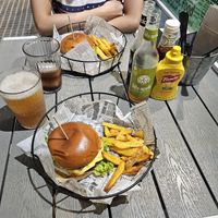American burger in the front and BBQ burger in the back. Ketchup and mustard are included for the fries and free of charge at Rúkula Vegan Food in Malaga