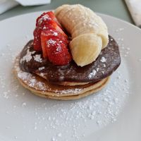 Pancakes with chocolate spread and fruit at Oásis da Lagoa in Vila Nova De Santo Andre