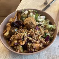 Vegan bowl with salads, seasonal veggies and arancini  at Café "das Goldstück" in Vienna