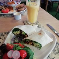Vegan Breakfast Burrito and fresh orange juice.  at Global Tribe Cafe in Leeds