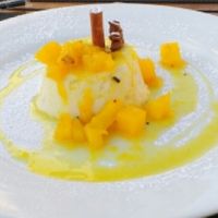 Coconut pudding with fruit reduction. at Essencia in Porto