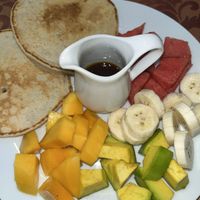 Pancakes with syrup and fruit salad  at Celery Vegan Restaurant in Cat Ba