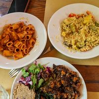 Pasta with vegetarian ragu (top left). Rice with vegetables (top right). Mixed plate with lentils (bottom) at Il Vegetariano in Florence