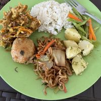 Steamed rice, garlic potatoes, beans, fried potato, fried veggies, and fried noodles   at Warung Rezeki in 