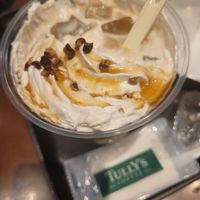 Oat milk latte with nuts and acorn sirup at Tully's Coffee in Osaka