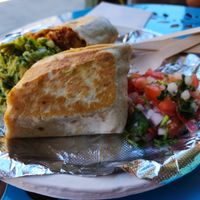 Chimichanga - Griddled flour tortilla filled with black or pinto beans, Mexican rice, corn salad, cheese sauce, and choice of soy protein at El Nopalito Vegan Taqueria in Hollywood