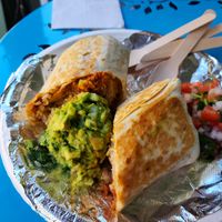 Chimichanga - Griddled flour tortilla filled with black or pinto beans, Mexican rice, corn salad, cheese sauce, and choice of soy protein at El Nopalito Vegan Taqueria in Hollywood