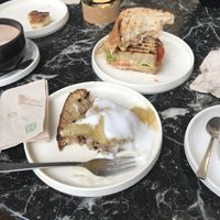 Grilled banana bread with yuzu jam and coconut yogurt , and a vegan sandwich with tomato , salad, chickpeas  at Weird Space Café in Dusseldorf