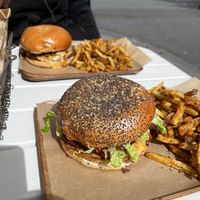 Two plates of burgers and fries  at Ginsburger Vegetarian Superstar in Paris
