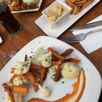 Vegan vegetable bravas and hummus and pitta chips.   at La Plaza in Malaga