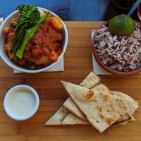 Indian choice... Veg curry, good hit of heat. Wild rice. Tzatziki and flatbread at La Plaza in Malaga