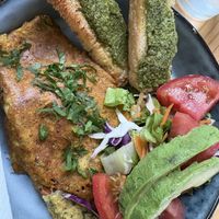 Omelette comes with salad and bread with amazing pesto spreadd  at PURALMA Vegan Bakery in San Jose
