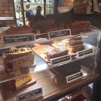 Cake counter - the two top rows (noted VE) are vegan at The Cosy Cafe in Hay-on-wye