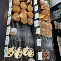 More baked goods, vegan pretzels and bagels (egg-free picture on the sign) on the bottom left  at Kameshima Bakery in Okinawa