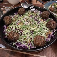 Charred Cabbage Salad: snowy cabbage, allium crunch, sweet onion soubise, carrot ginger dressing + falafel add-on  at Twelvemonth in Burlingame