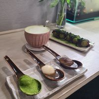 Miso dango in spoon/ matcha & anko cakes in background at Cafe Chairo in Tokyo