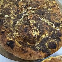 Zatar pie - looks dry but wasn’t at all   at Basha Bakery & Restaurant in Freetown