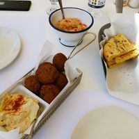 Falafel and aubergine paste next to pita. at Ke Kremmydi in Idra