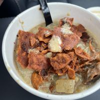 Cup of clam chowder with bacon bits sprinkled on top  at Love It Vegan  in Torrington