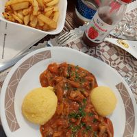 Fries and mushroom stew with polenta at Sergiana in Brasov