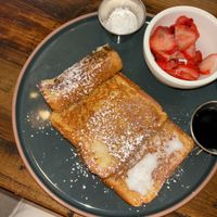 French toast (half a slice eaten) with whipped cream and maple syrup! I asked for all berries as the fruit side (+$1)  at The Ginger Mule in Houston