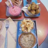 Hummus with beetroot, wild potatoes with barbecue sauce, salty rice cake, cauliflower. at Flora et Labora in Milan