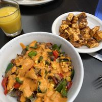 Bionic breakfast with a side of tofu cubes. Pictured behind is the short stack (vegetarian, but not vegan) and some OJ!   at Ria's Bluebird in Atlanta