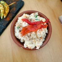 Ensaladilla rusa. Súper rica, con el toque de kala namak por encima tenía un gusto a huevo muy bueno. at La Vegana Taperia Playa in Torre Del Mar