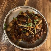 Samosa Chaat - Samosa filled with pea and potatoes with chickpea curry and yogurt on top. (Ask to remove the yogurt for a vegan dish)   at Madam Chutney in Munich