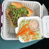 Half of the Vegan Bahn Mi - the other half was delicious! Plenty of veggies under the fried tofu slices and faux meat strips, the small box of extras and dressing are a salad !  at M&T Restaurant in Silverdale