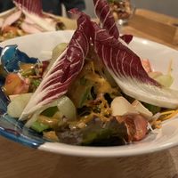 Smoked tofu and vegetable salad with the nuts in the background  at LINNAS in Kanazawa