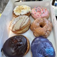 Box of donuts! Clockwise from top left: lemon crunch, strawb frosted, vanilla glaze, blueb creme, Boston creme, French toast   at Bitchin Donuts in Albany