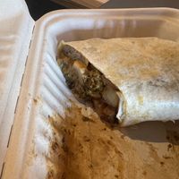 One half of a half-eaten breakfast burrito  at Bitchin Donuts in Albany
